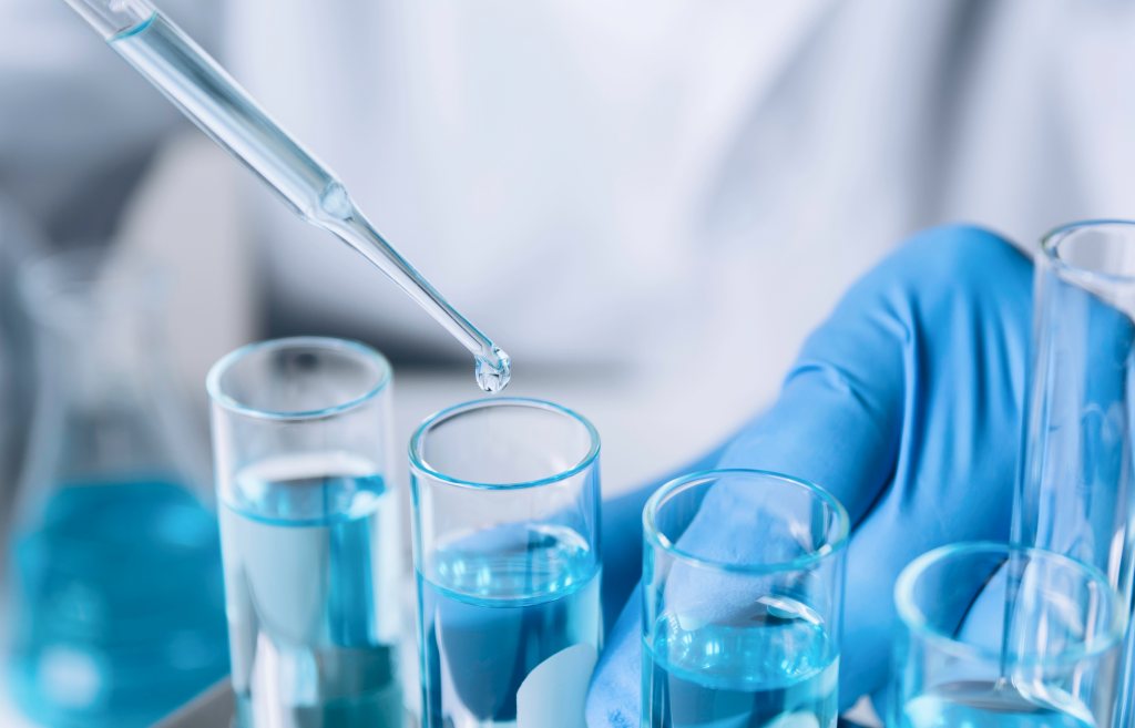 A researcher handling test tubes in a laboratory